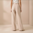 Beige FJØRNA high-waist wide-leg women’s pants, loose pull-on trousers with relaxed fit and tailored style.