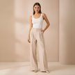 Beige high-waist, wide-leg pull-on pants for women by FJØRNA, showcasing a relaxed, loose fit and comfortable style.