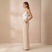 Beige high-waist wide-leg tailored pants for women by FJØRNA, loose pull-on style, perfect for casual or professional wear.