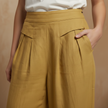 White high-waist cotton linen wide-leg trousers for women with pockets, by FJØRNA, styled with a relaxed fit and natural fabric.