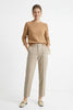 Women's Merino wool tapered trousers by FJØRNA, featuring a comfortable fit and classic design in neutral tones.