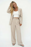 White wide-leg high-waist trousers for women by FJØRNA, featuring a relaxed fit and high-rise design.