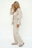 White wide-leg high-waist women's trousers from FJØRNA with a relaxed fit and tailored design, shown on a model.