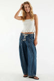 FJØRNA women's wide-leg cotton jeans with drawstring waist, showcased in a casual outfit on a model.