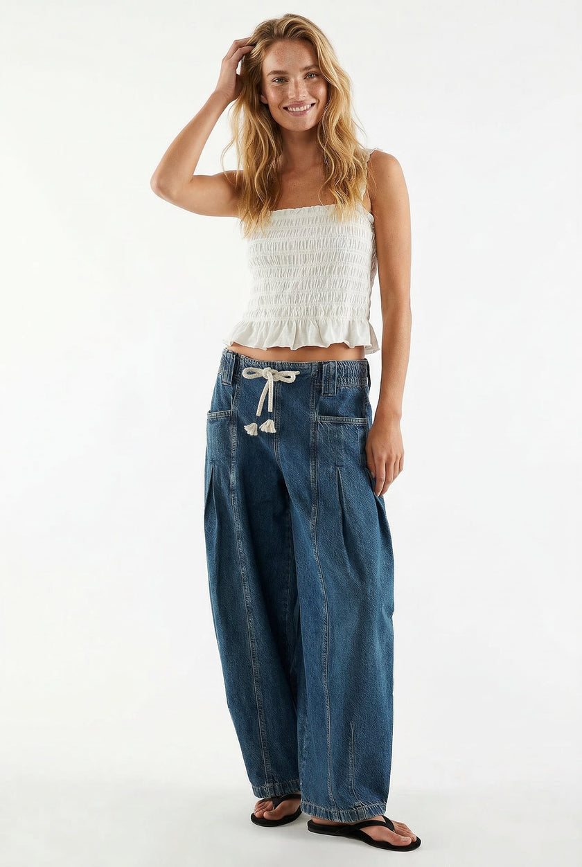 FJØRNA women's wide-leg cotton jeans with drawstring waist, showcased in a casual outfit on a model.
