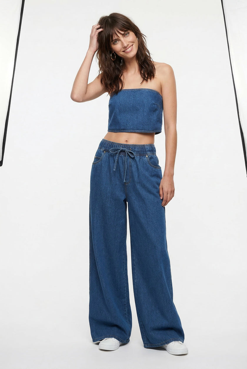 Blue denim wide-leg drawstring jeans for women by FJØRNA, relaxed fit pants with a casual, stylish design.