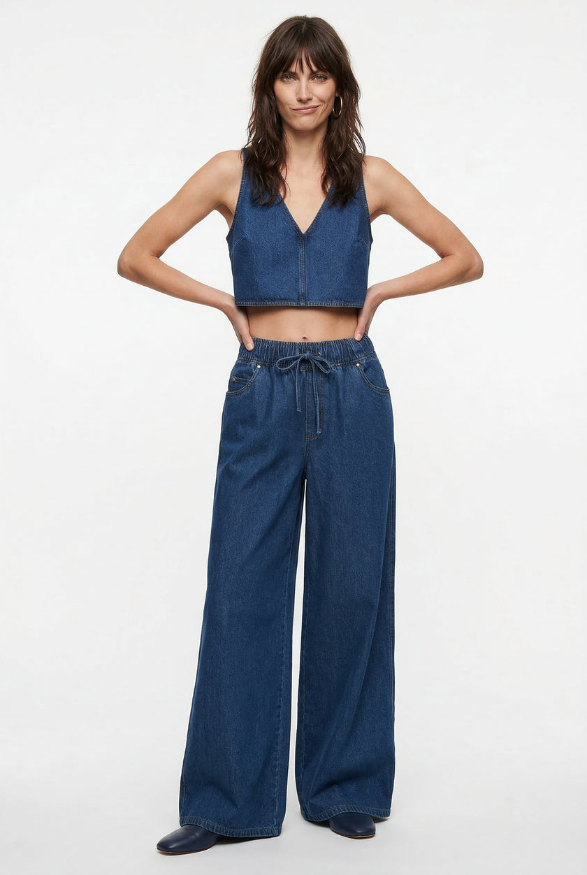 Blue denim wide-leg drawstring jeans for women by FJØRNA, shown on a relaxed-fit model with casual styling.