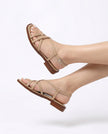 FJØRNA Italian leather cushioned women's brown sandals worn by a model with white-painted toes, studio shot on white background.