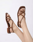 FJØRNA Italian leather cushioned women's brown sandals worn by a model, featuring white-painted toenails and stylish poses.