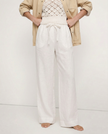 FJØRNA linen wide-leg trousers for women, loose pull-on pants with soft fabric and relaxed fit, shown on a model.