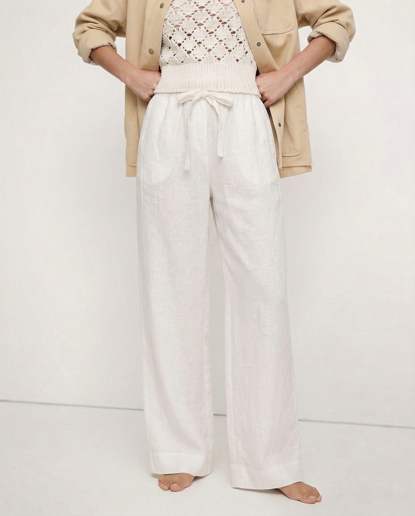 FJØRNA linen wide-leg trousers for women, loose pull-on pants with soft fabric and relaxed fit, shown on a model.