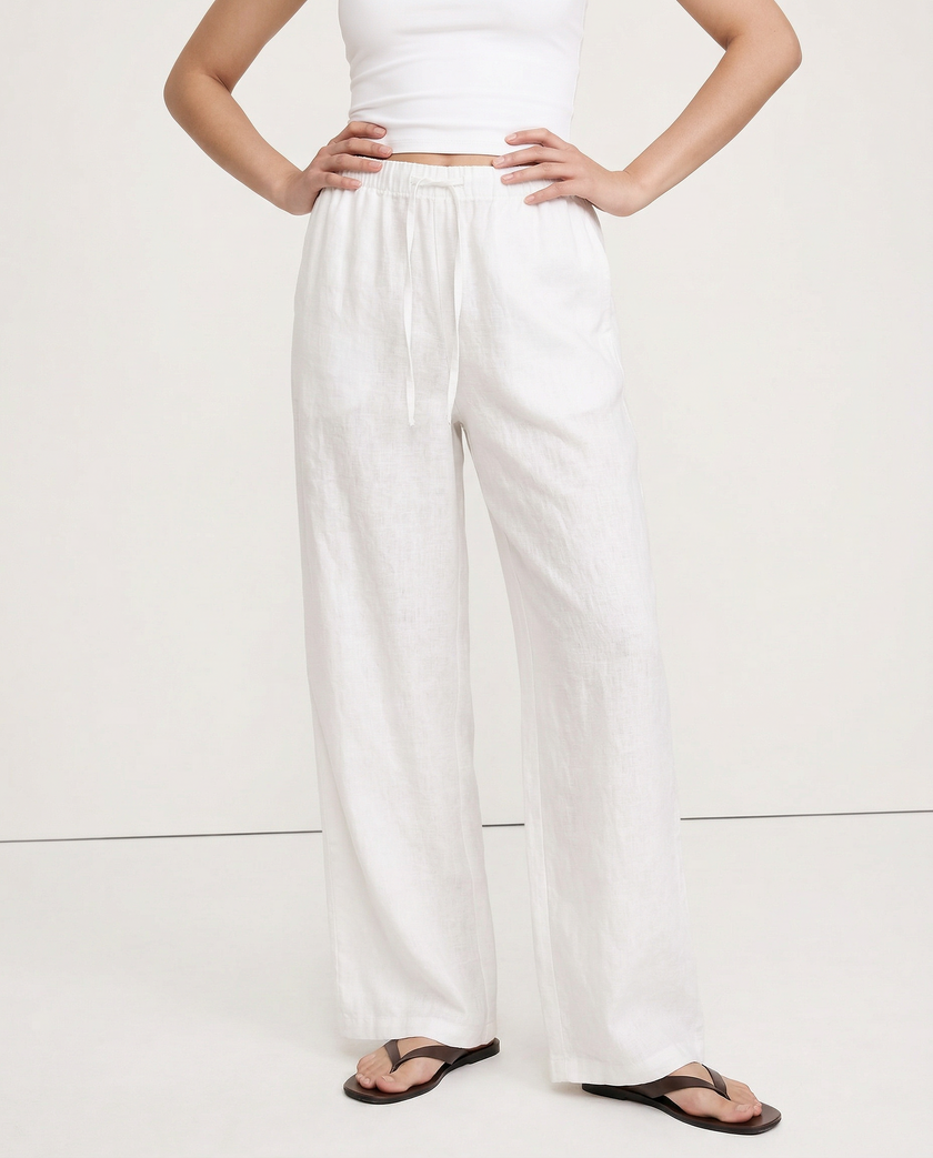 FJØRNA women's knit wide leg trousers with drawstring waist, showcasing soft fabric and relaxed fit in a natural pose.