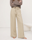 FJØRNA linen wide-leg trousers for women, loose pull-on pants with soft fabric and relaxed fit, shown on a model.