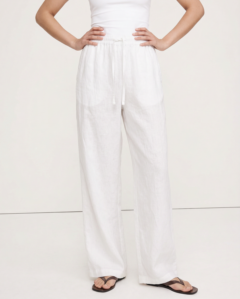 FJØRNA women's knit wide-leg trousers with drawstring waist, showcasing soft fabric and relaxed fit in a natural pose.