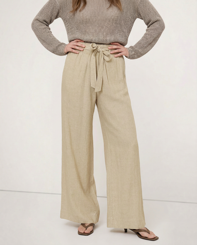 FJØRNA linen wide-leg women's pants with loose fit, pull-on style, showcasing soft fabric and relaxed fit in a natural pose.