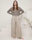 FJØRNA linen wide-leg women’s trousers in a loose pull-on style, showcasing soft, high-quality fabric and relaxed fit.
