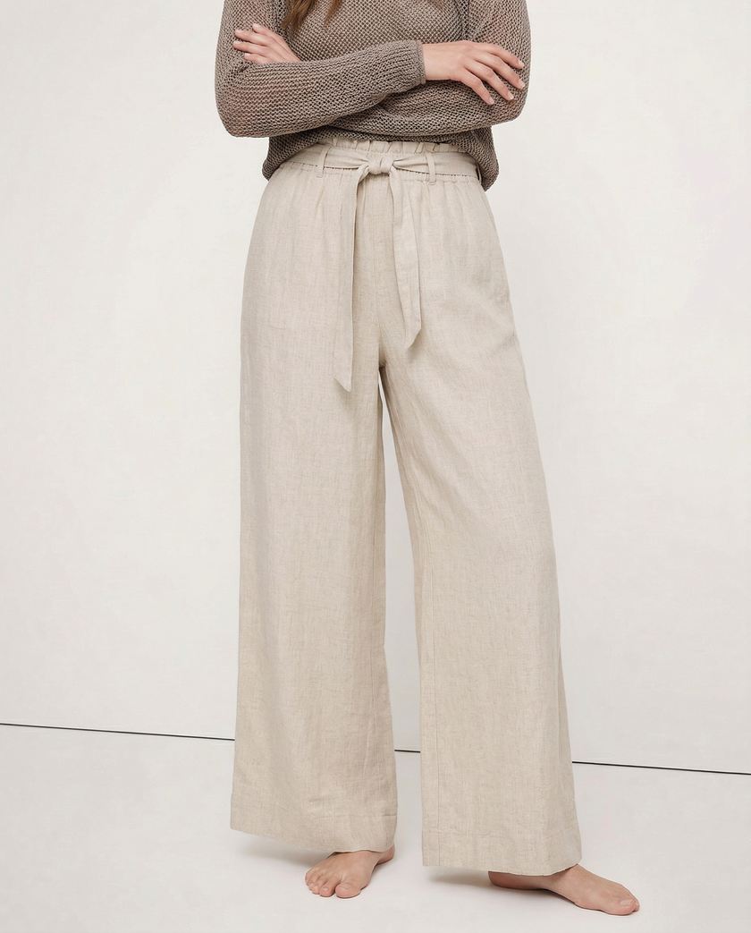 FJØRNA linen wide-leg women's trousers, loose pull-on pants showing soft fabric and relaxed fit on model.