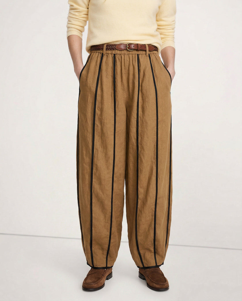 FJØRNA linen wide-leg trousers for women with elastic waist, showcasing high-quality, realistic linen fabric in a natural pose.