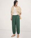 FJØRNA linen wide-leg women's trousers with elastic waist, showing high-quality linen fabric and relaxed fit.