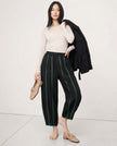 FJØRNA linen wide-leg women's trousers with elastic waistband, showing high-quality, breathable linen fabric in a realistic, stylish fit.
