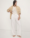 FJØRNA linen wide-leg women’s trousers with a loose fit, showing soft fabric texture and relaxed style.