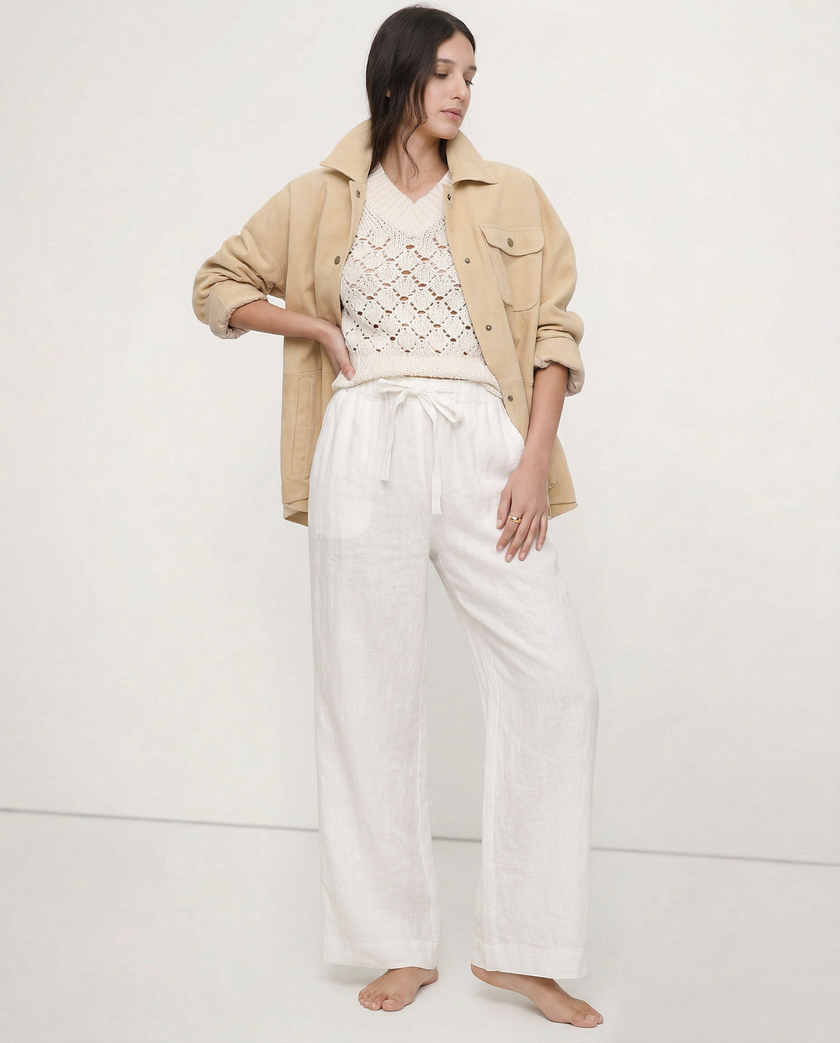 FJØRNA linen wide-leg women’s trousers with a loose fit, showing soft fabric texture and relaxed style.