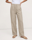 FJØRNA women's knit wide-leg trousers with drawstring waist, shown on a model, featuring a relaxed fit and soft fabric.