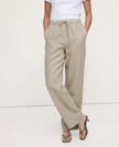 FJØRNA women's knit wide-leg trousers with drawstring waist, relaxed fit, and soft fabric, worn by a model in a casual setting.