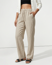 FJØRNA women's knit wide-leg trousers with drawstring waist, shown on a model, featuring a relaxed fit and comfortable style.