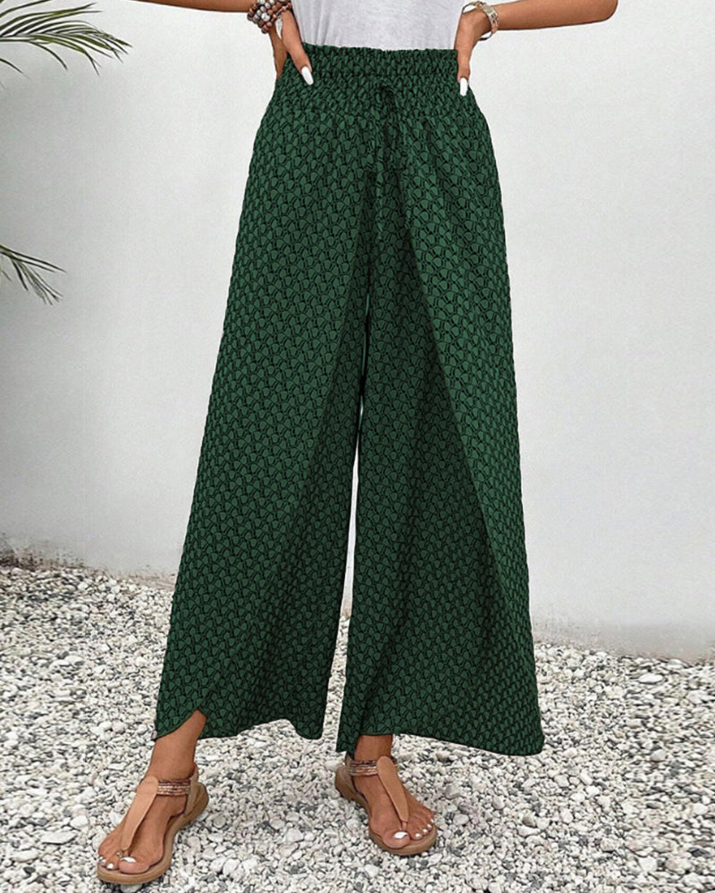 Green FJØRNA women's lightweight summer trousers with wide leg design and breathable fabric, perfect for warm weather wear.