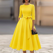 FJØRNA crew-neck A-line midi dress for wedding guests, elegant midi dress with a fitted waist and flowing skirt, in soft fabric.