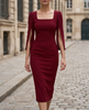 FJØRNA square-neck slit-sleeve midi cocktail dress displayed on a hanger, showcasing its elegant design and fabric details.