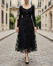 Black 3D floral embroidered mesh knit midi dress by FJØRNA, featuring intricate floral embroidery and a fitted silhouette.