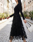 Black 3D floral embroidered mesh knit midi dress by FJØRNA, featuring intricate floral embroidery and a fitted silhouette.