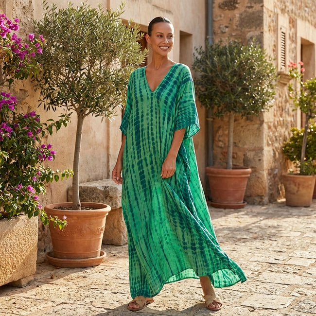 FJØRNA boho printed maxi dress featuring a loose fit and V-neck, flowing fabric with colorful bohemian patterns.