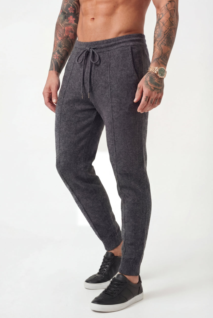 Men's dark grey merino wool trousers by FJØRNA, stylish and comfortable pants with a tailored fit and smooth fabric.