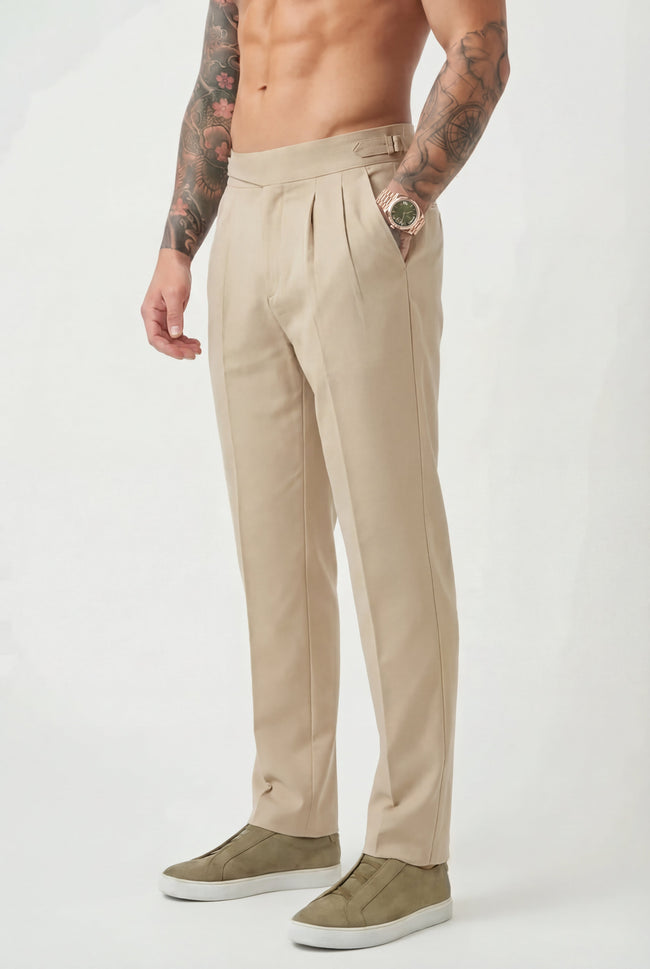 Men's tailored cream trousers by FJØRNA, featuring a sleek fit and classic design, shown on a model.