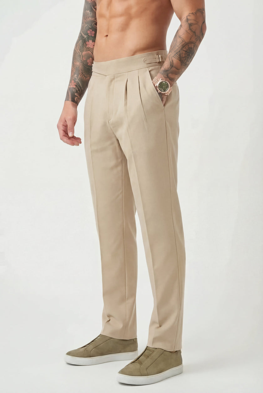 Men's tailored cream trousers by FJØRNA, featuring a sleek fit and classic design, shown on a model.