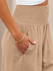 FJØRNA women's linen summer trousers with high waist and wide-leg design, made from cotton and linen fabric.
