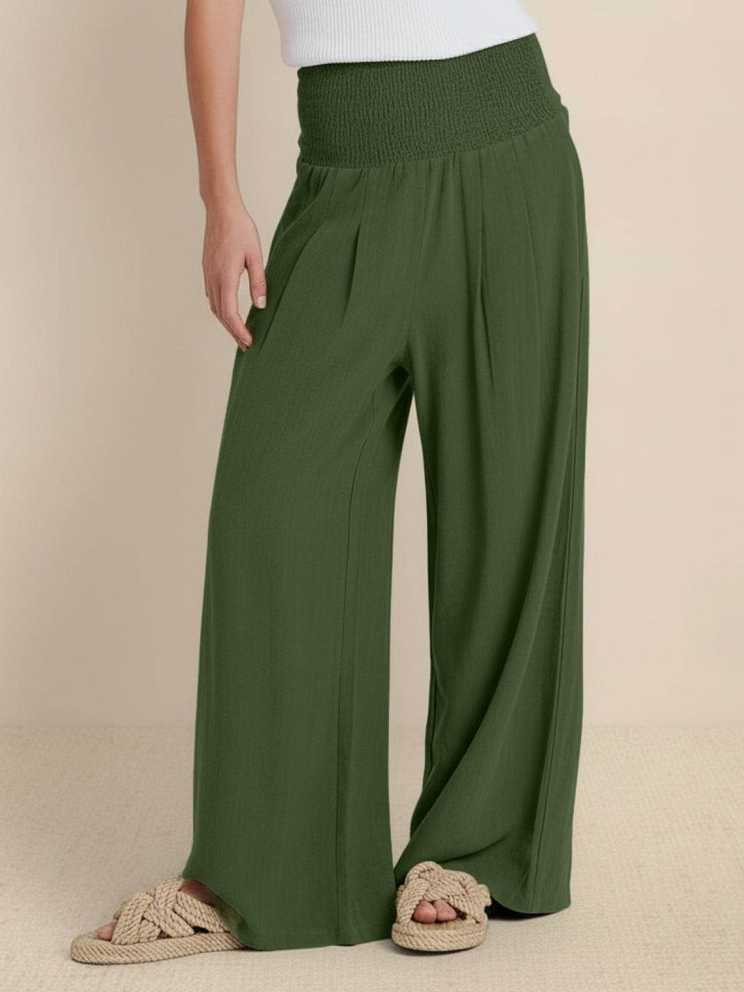 High-waist linen summer trousers for women by FJØRNA, wide-leg palazzo style, made of lightweight cotton and linen fabric.