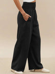 FJØRNA women's linen summer trousers with high waist and wide-leg design, made of lightweight cotton-linen fabric.