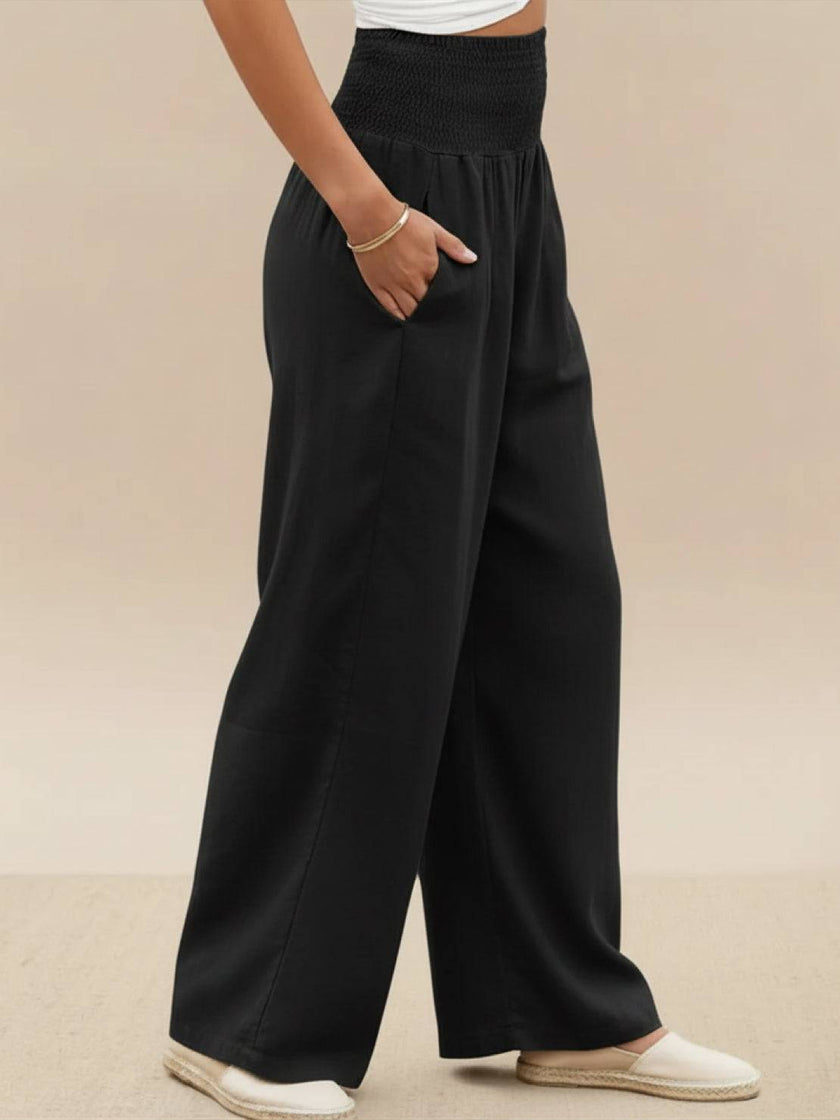 FJØRNA women's linen summer trousers with high waist and wide-leg design, made of lightweight cotton-linen fabric.