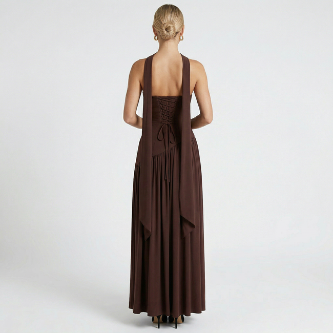 FJØRNA women's elegant strapless maxi dress showcasing a flowing fabric and fitted bodice on a model.