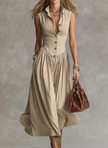 FJØRNA Martina elegant white flowy midi dress displayed on a hanger with soft fabric details.