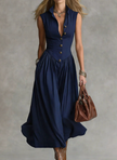 FJØRNA Martina elegant white flowy midi dress displayed on a hanger with soft fabric details and feminine silhouette.