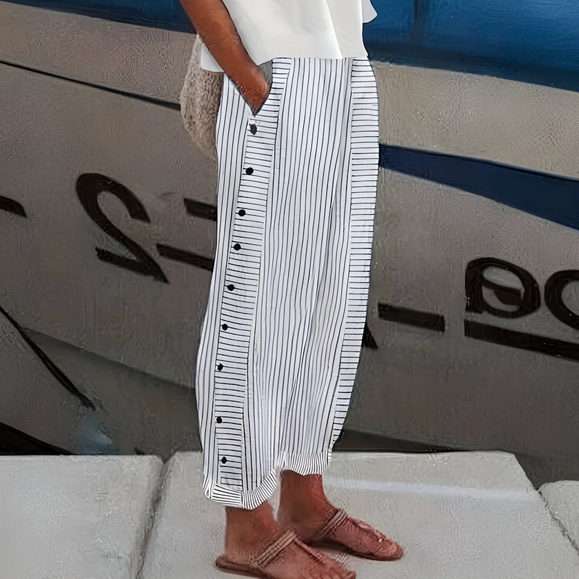 FJØRNA lightweight summer trousers for women with straight leg and elastic waist, shown in a relaxed fit on a model.