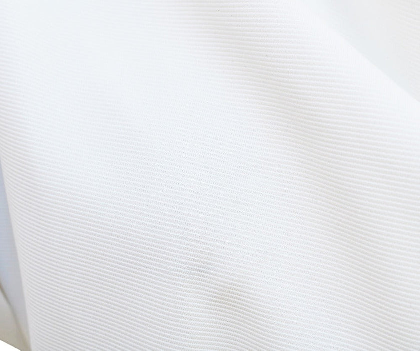 White FJØRNA bat sleeve waist-cinching dress with elegant design, featuring fashionable bat sleeves and a sleek silhouette.