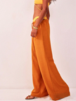 FJØRNA linen-blend wide-leg women’s trousers with a loose pull-on design, shown in a relaxed fit on a model.