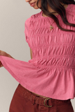 FJØRNA linen ruched ruffle top for women, casual linen top with gathered details and ruffled accents, shown on a model.