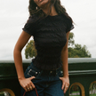 White plaid ruffle-detail women's top by FJØRNA, stylish blouse with feminine ruffles and plaid pattern, perfect for casual or dressy wear.